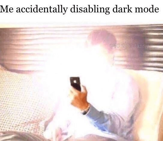 Meme of a man holding an extremely bright phone screen with caption "Me accidentally disabing dark mode"